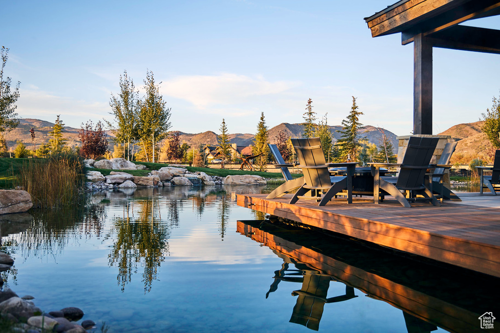 View of dock featuring a water and mountain view