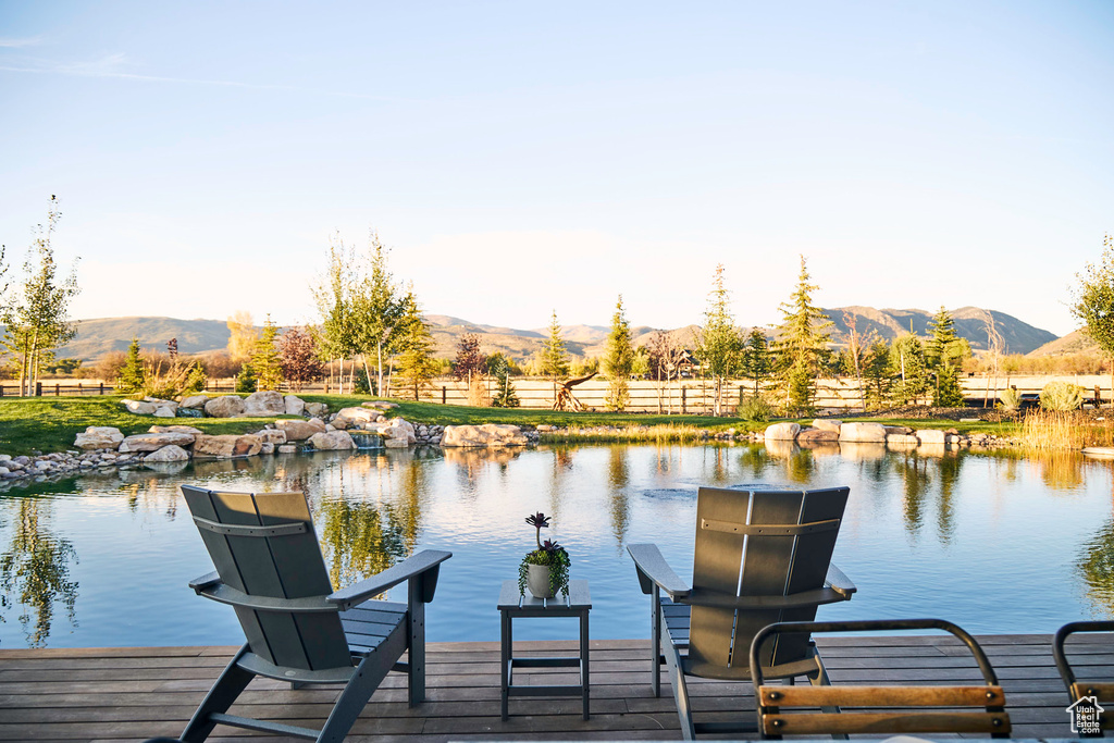 Dock area with a water and mountain view