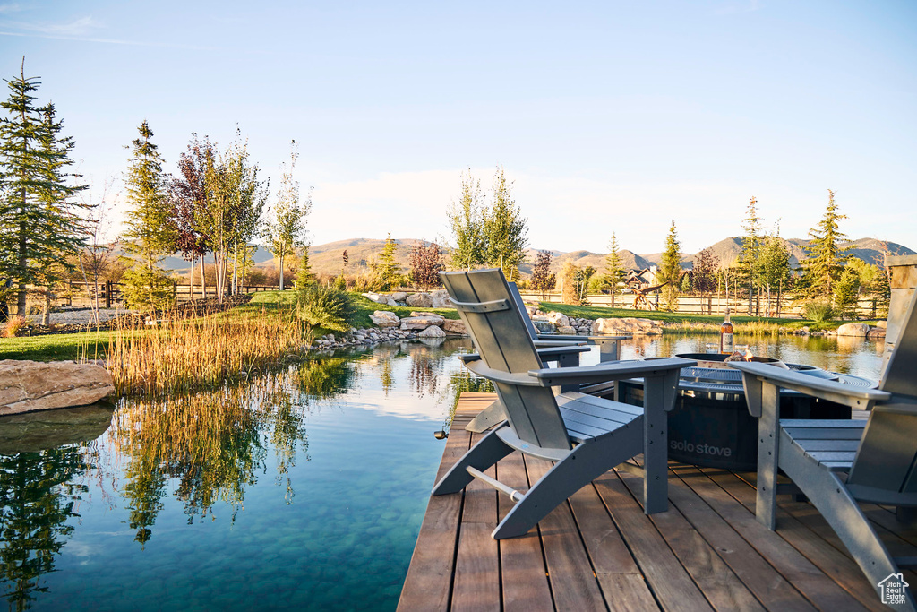 Dock area with a water and mountain view