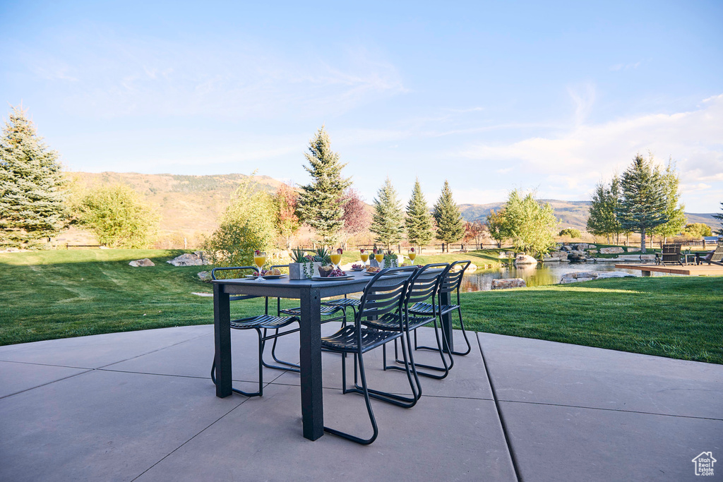 View of patio with a water and mountain view