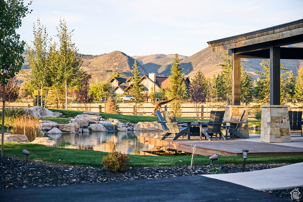 View of community with a deck with mountain view