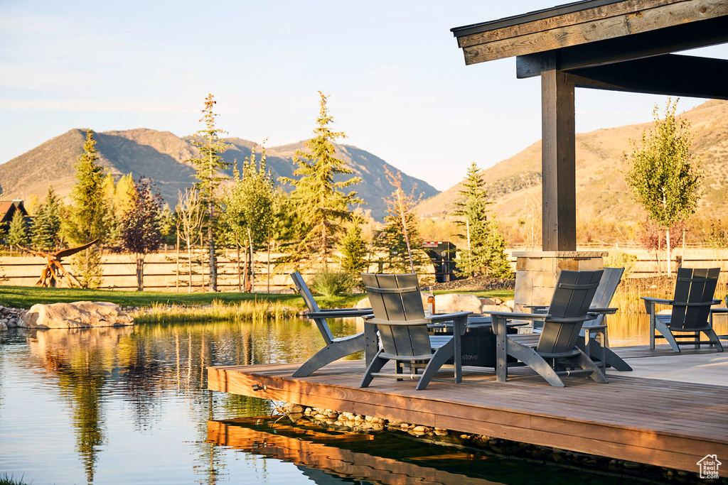 Deck featuring a water and mountain view