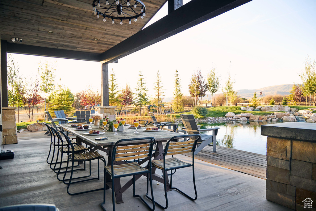 View of patio / terrace featuring a deck with water view