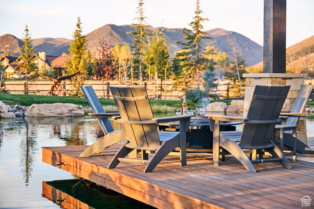 Wooden deck with a water and mountain view