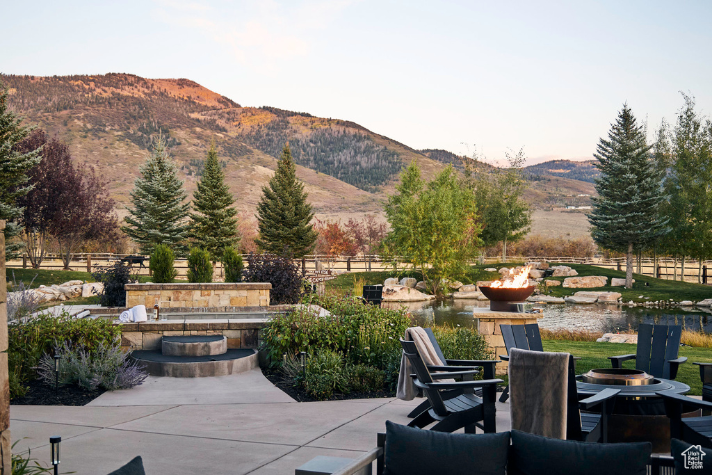 View of patio featuring a mountain view and an outdoor fire pit