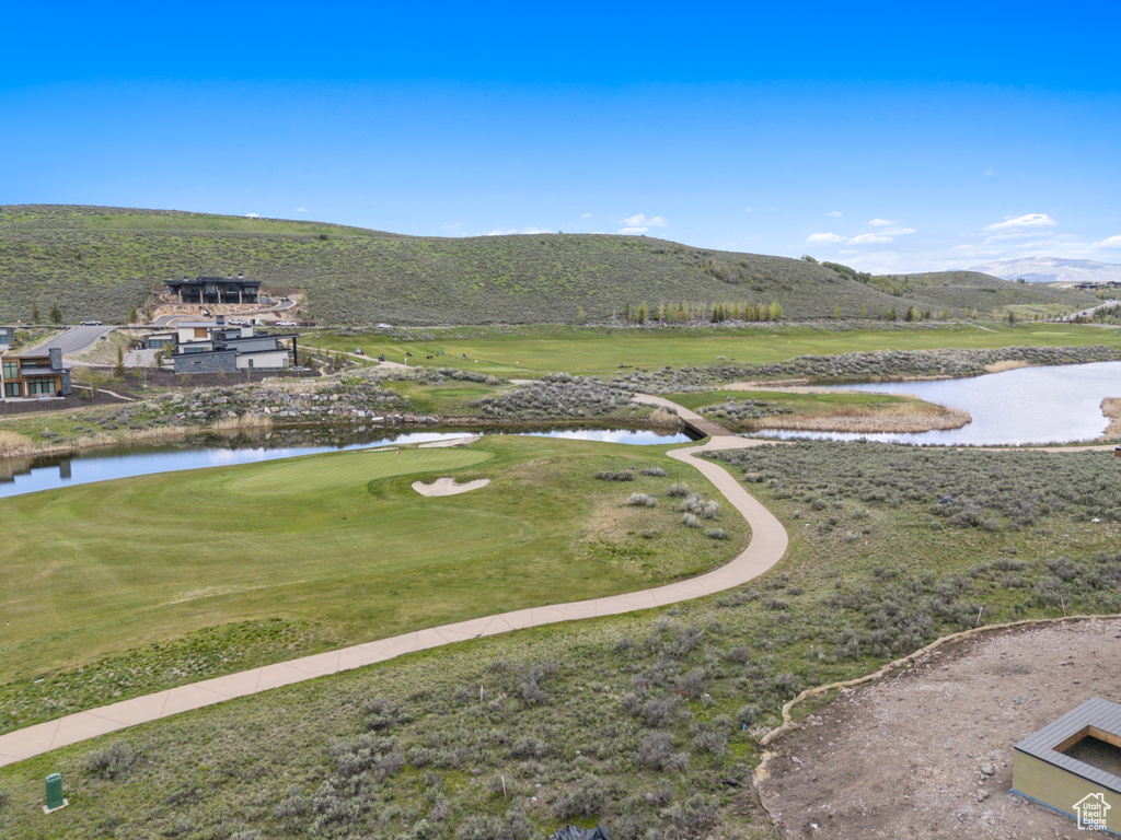 View of mountain background featuring a large body of water and a local golf course