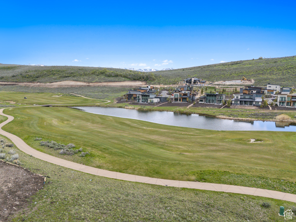 Aerial perspective of suburban area featuring a water and mountain view and a local golf course
