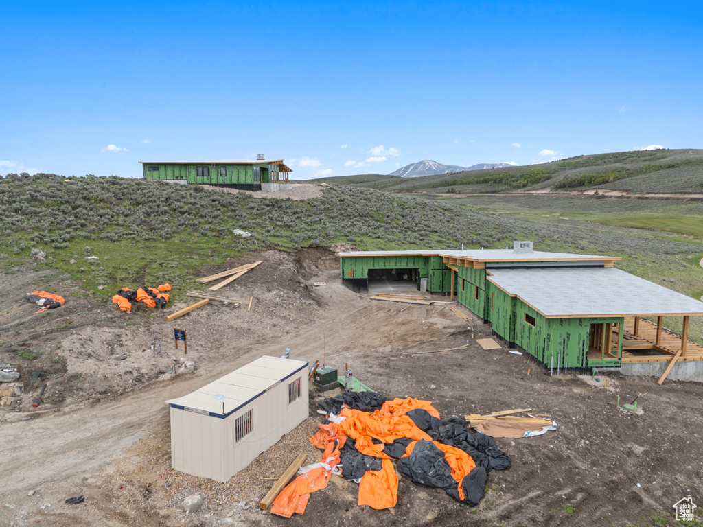 Aerial view of property and surrounding area with a mountainous background