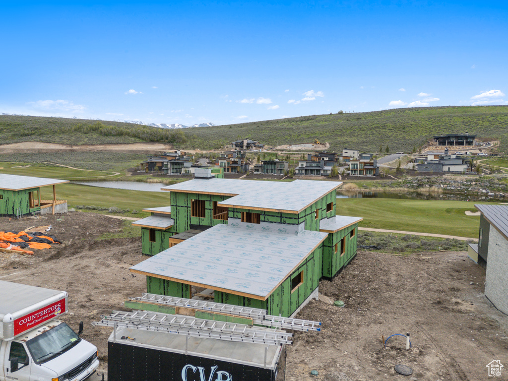 Drone / aerial view of a water and mountain view and a local golf course