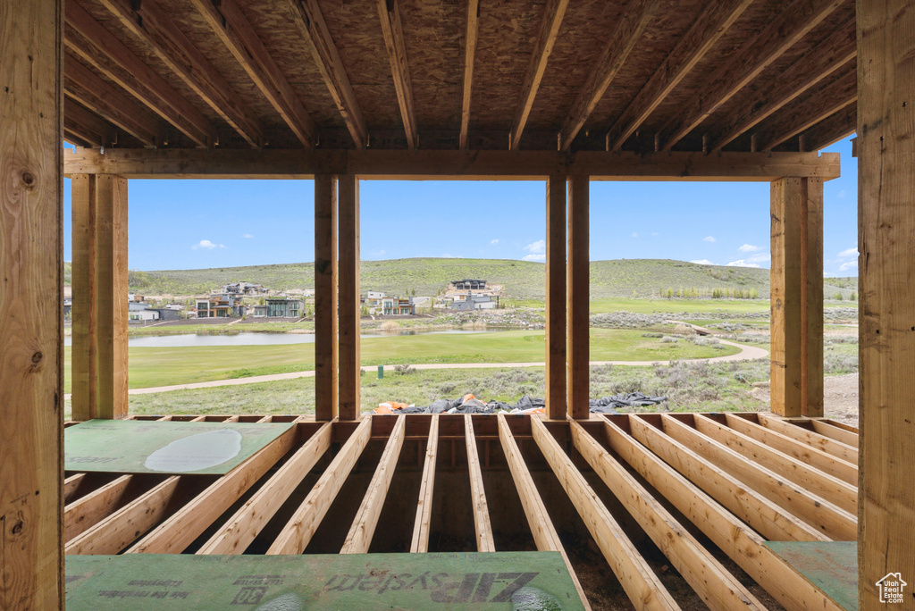 Interior space featuring a water and mountain view and a yard
