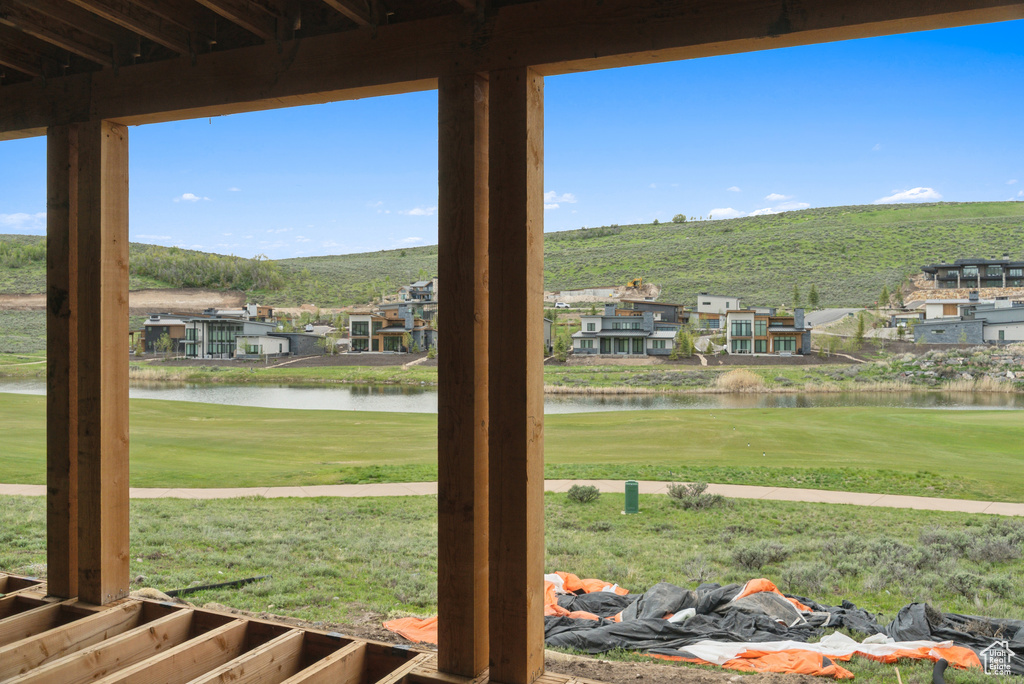 View of green lawn featuring a water view and view of golf course