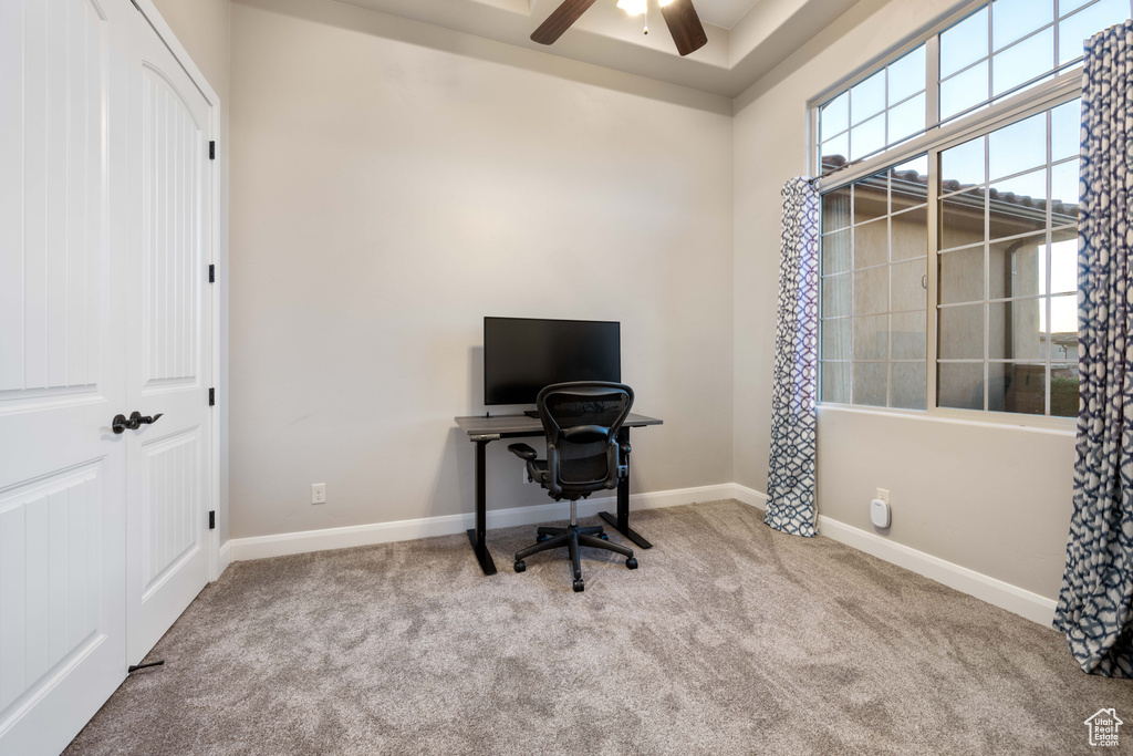 Carpeted office space with ceiling fan