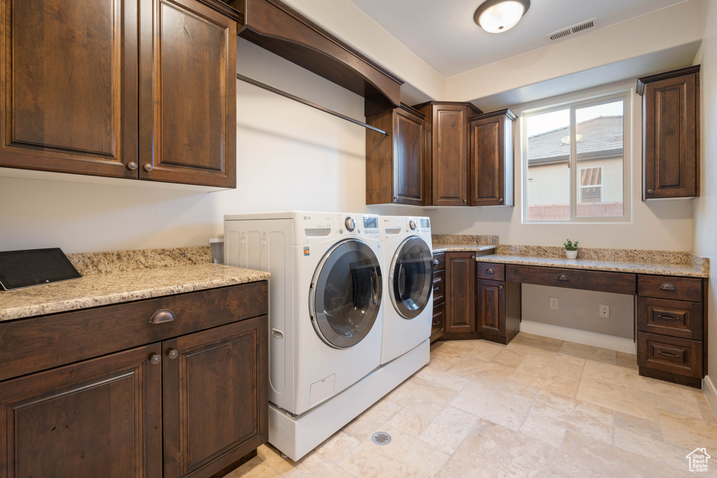 Laundry area featuring cabinets and independent washer and dryer