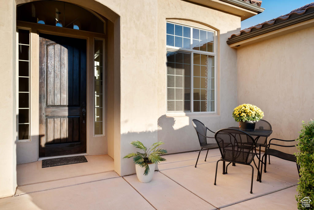 Doorway to property featuring a patio area