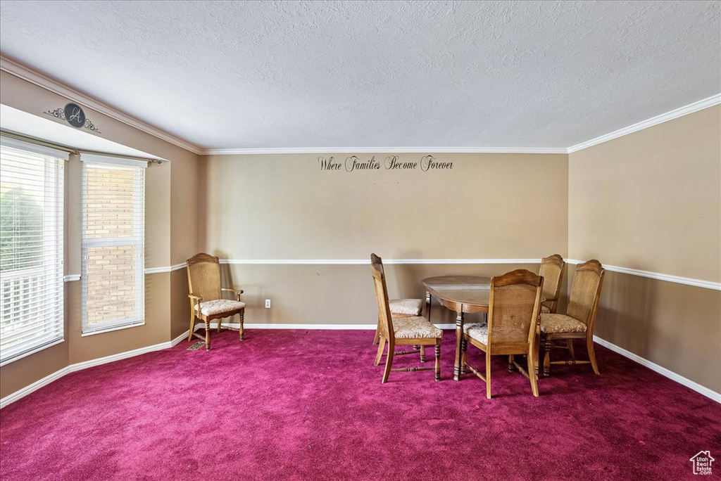Dining area featuring crown molding, a textured ceiling, and carpet flooring