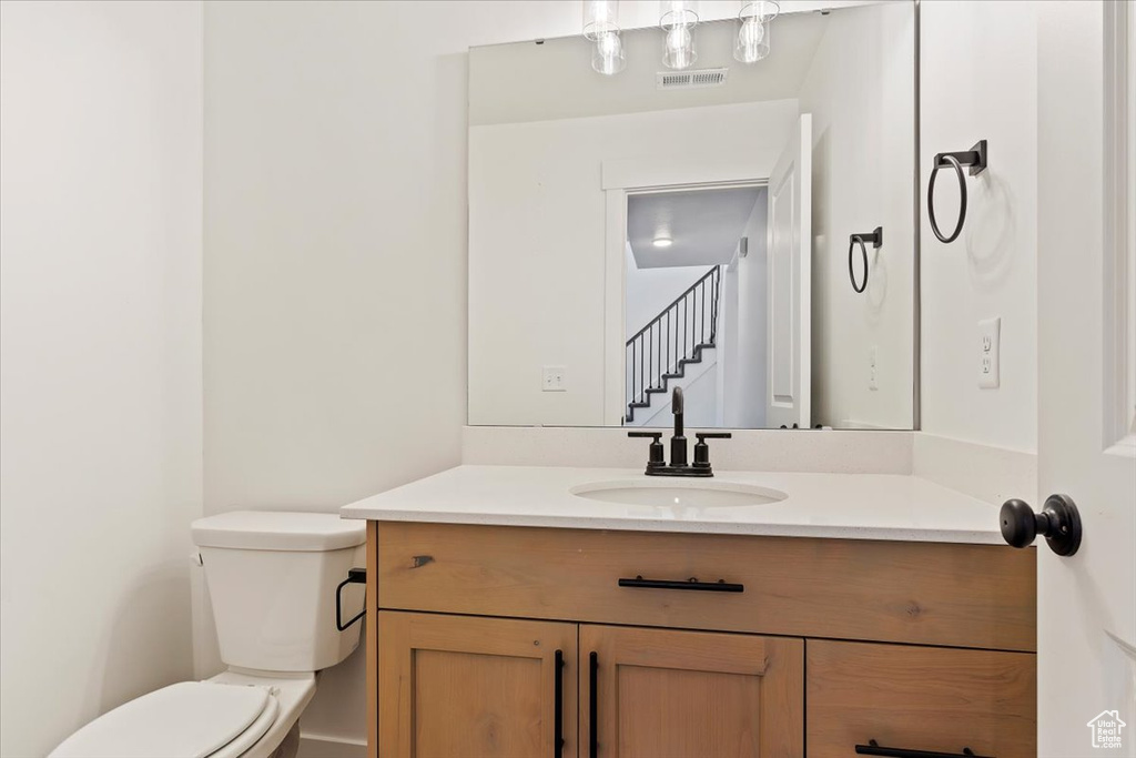 Bathroom featuring vanity and toilet