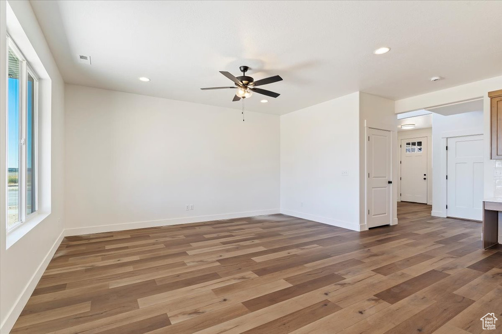 Spare room with dark hardwood / wood-style floors and ceiling fan