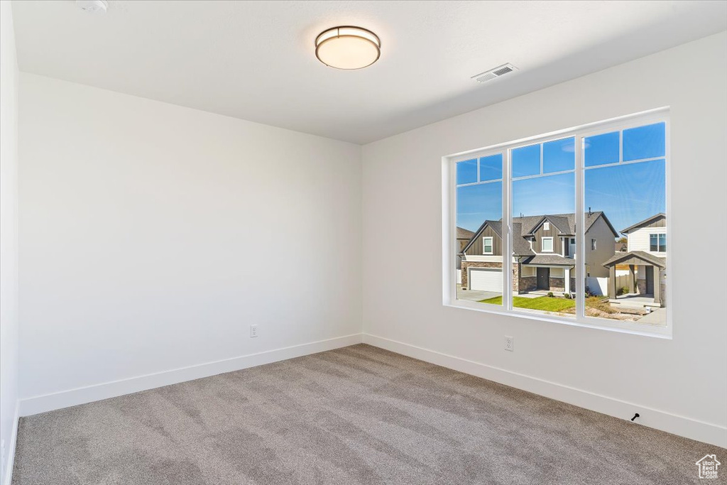 Spare room featuring carpet flooring