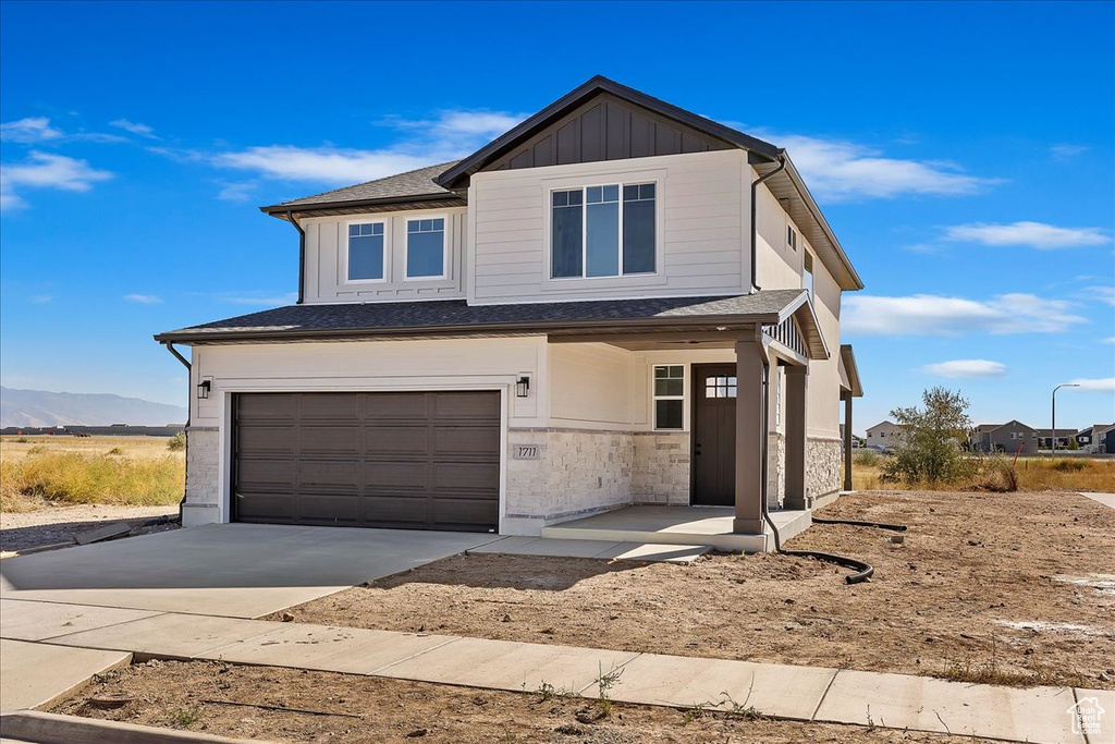 View of front of home featuring a garage and a mountain view