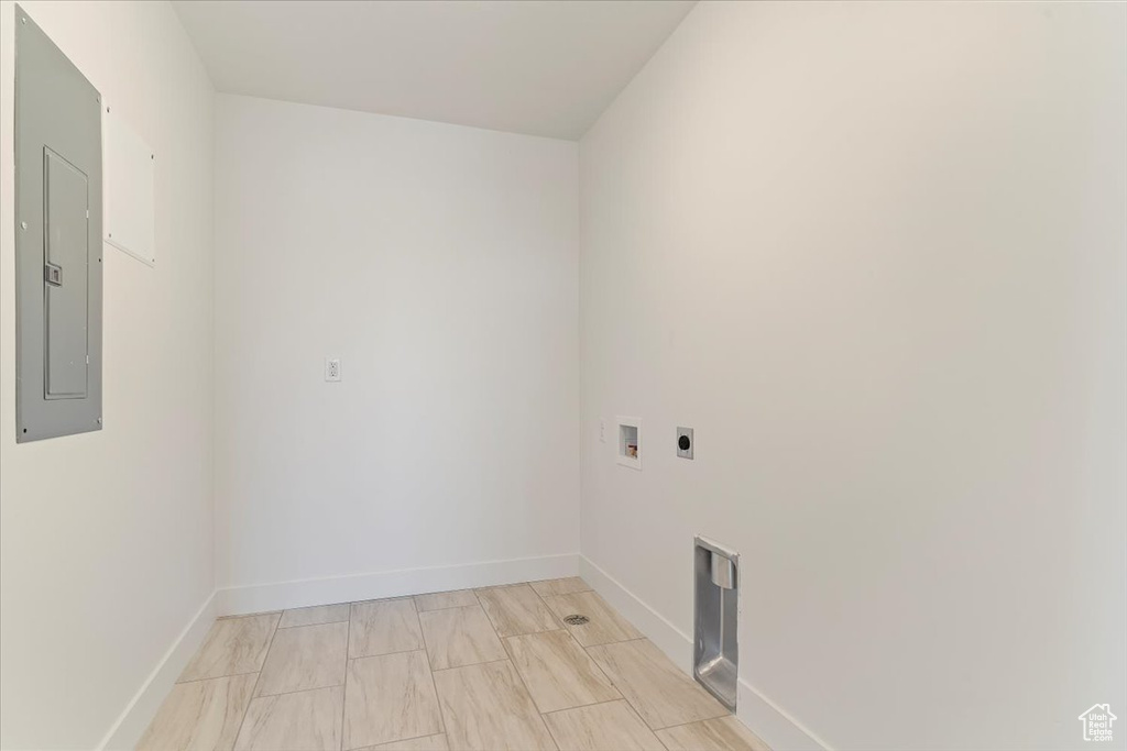 Washroom with hookup for a washing machine, electric panel, and hookup for an electric dryer