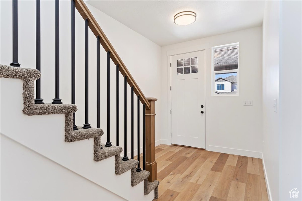 Foyer with light hardwood / wood-style floors