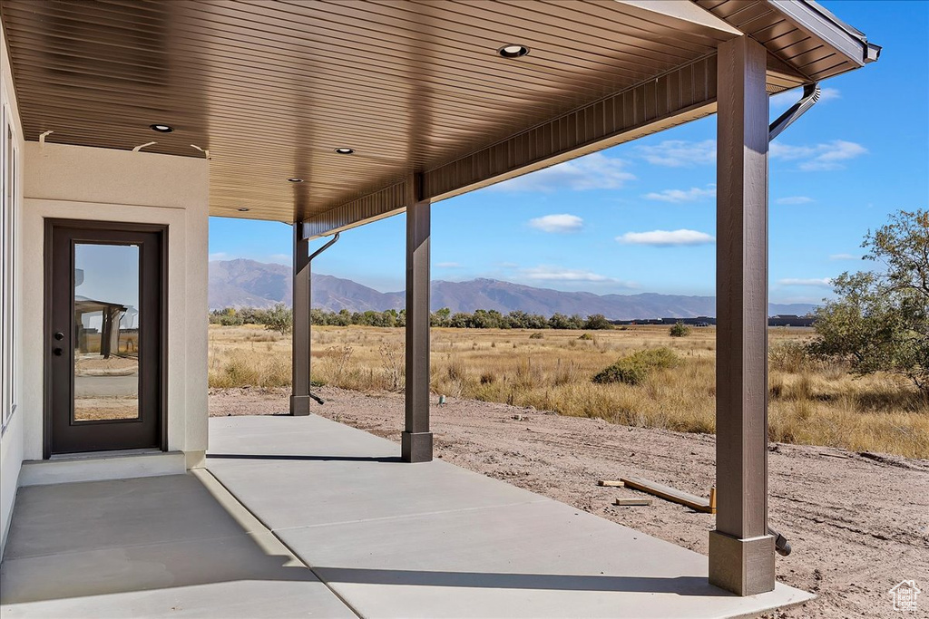 View of patio / terrace with a mountain view and a rural view