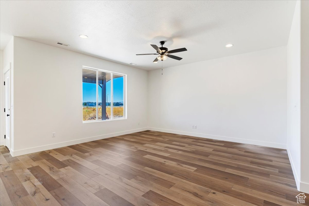 Spare room featuring hardwood / wood-style flooring and ceiling fan