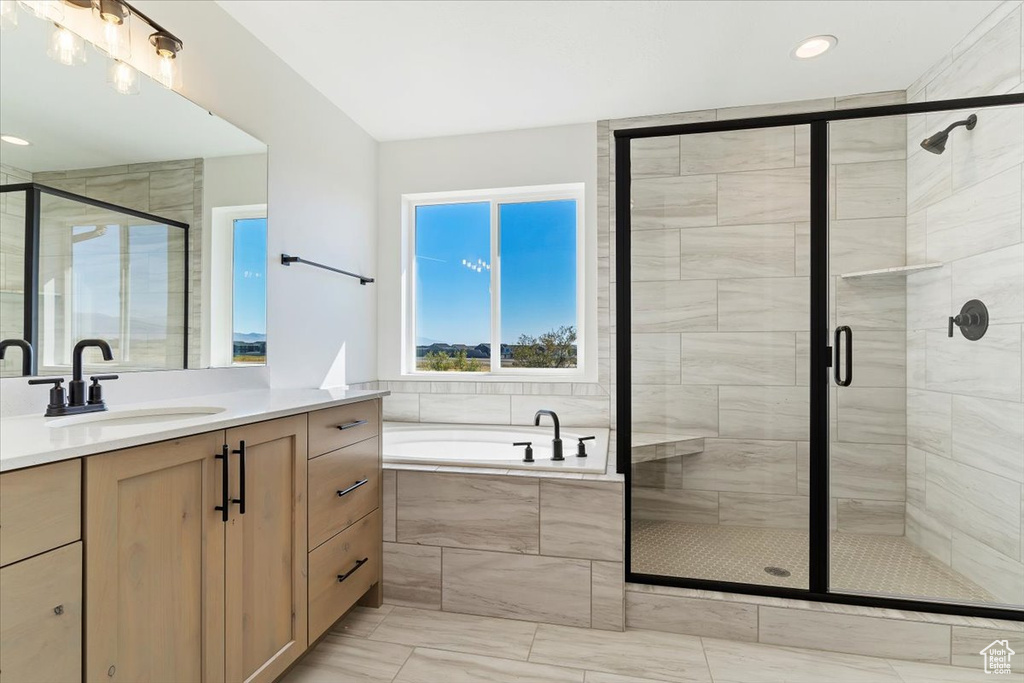 Bathroom featuring vanity and plus walk in shower