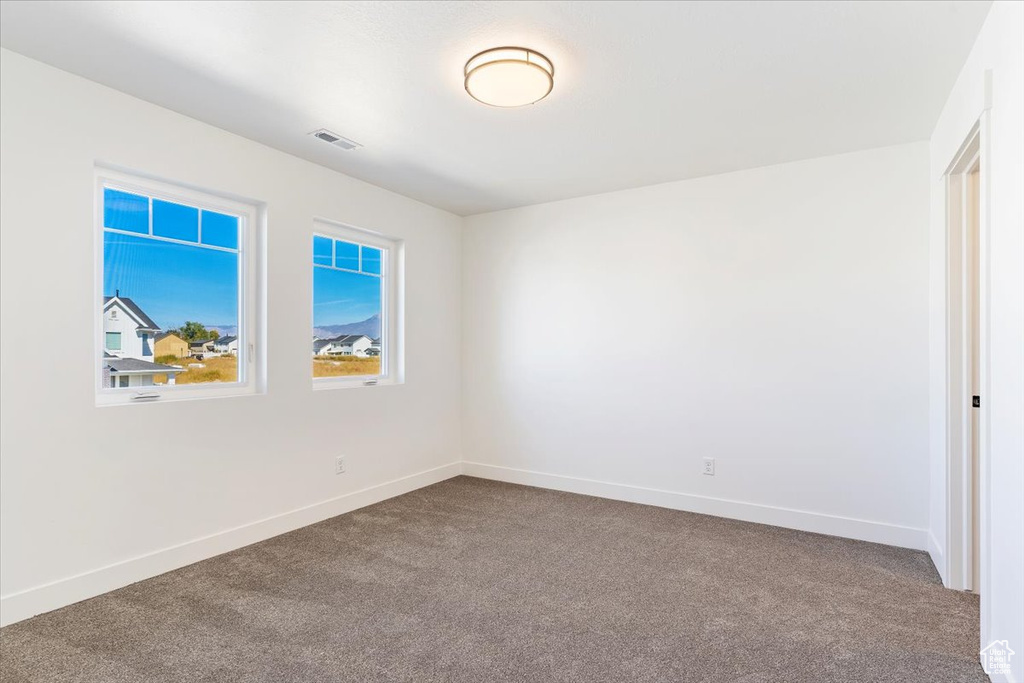 Spare room featuring carpet flooring