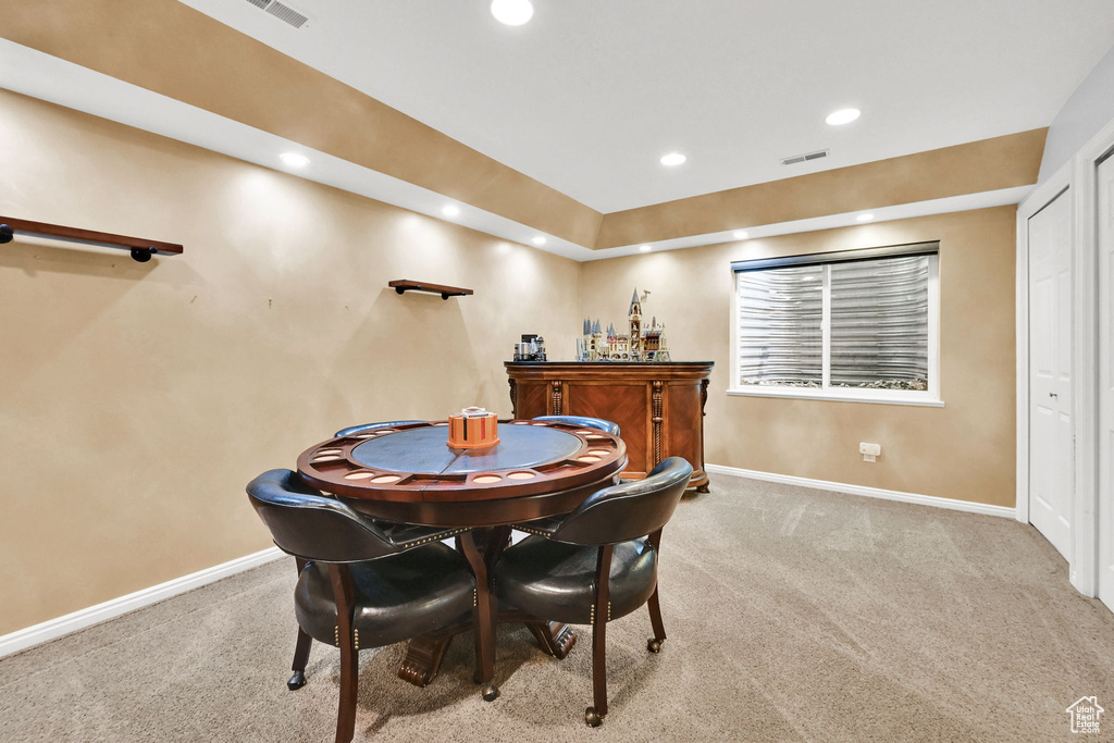 Dining space with light carpet, baseboards, recessed lighting, and a dry bar