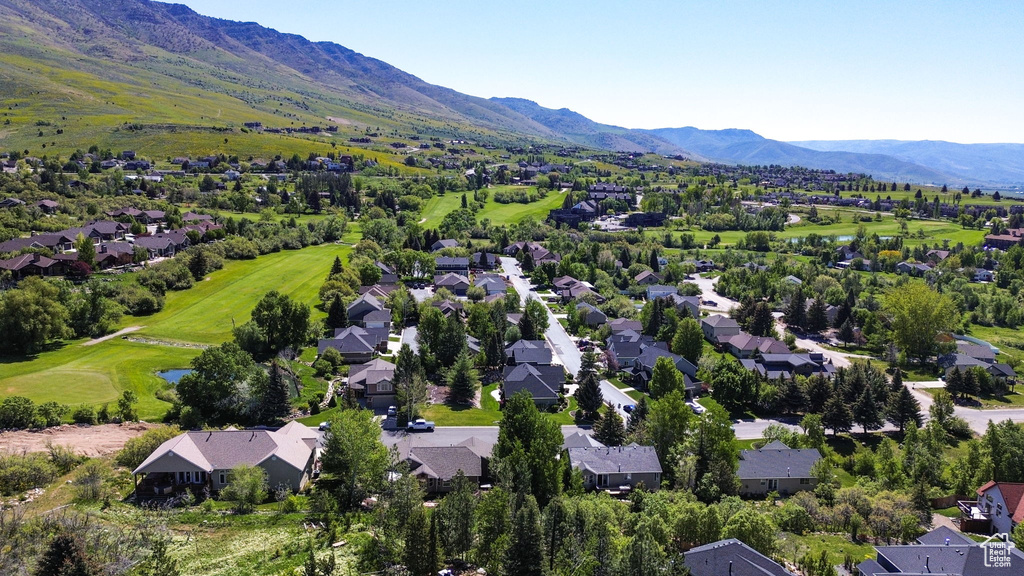 Aerial view of residential area with a water and mountain view and a golf club