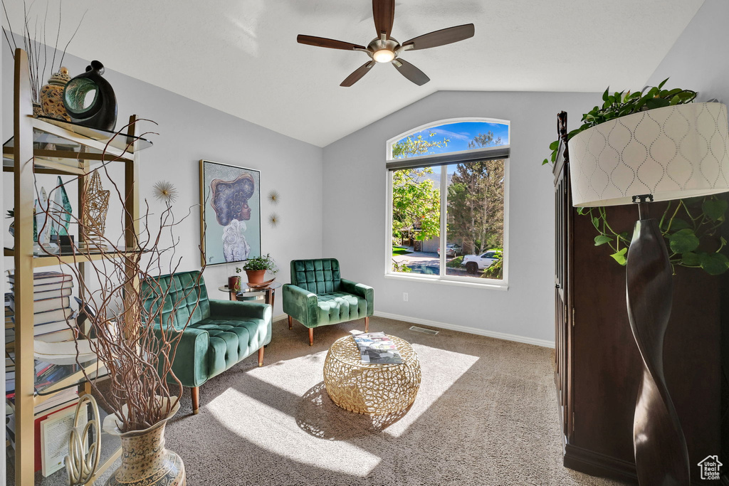 Sitting room featuring vaulted ceiling, a ceiling fan, carpet, and baseboards