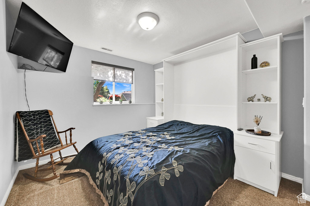 Bedroom with carpet and baseboards