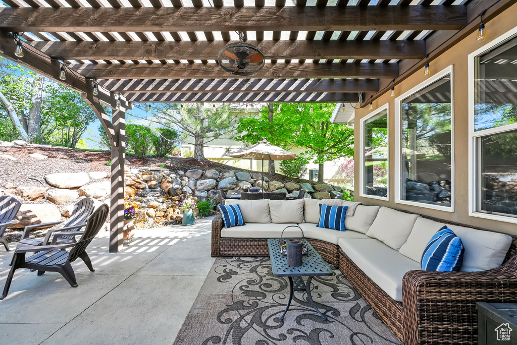 View of patio with an outdoor hangout area and a pergola