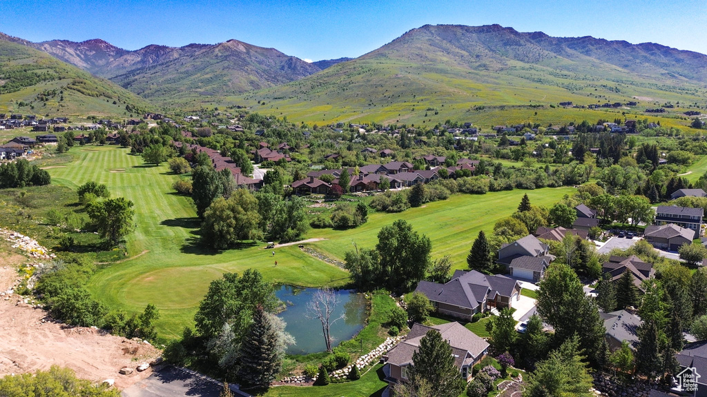Aerial view of residential area with a water and mountain view and a local golf course