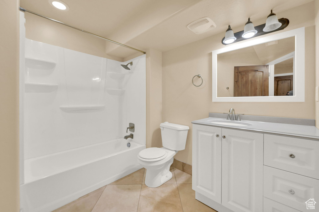 Full bathroom with  shower combination, vanity, toilet, and tile patterned floors