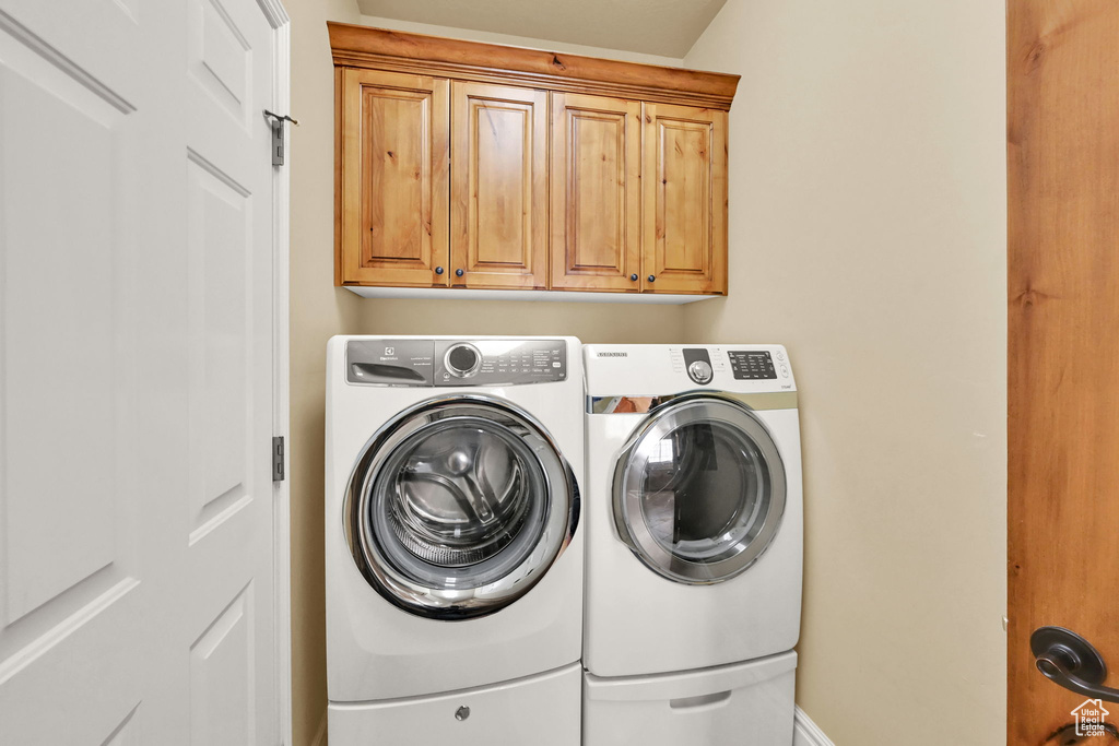 Laundry area with cabinets and washer and dryer