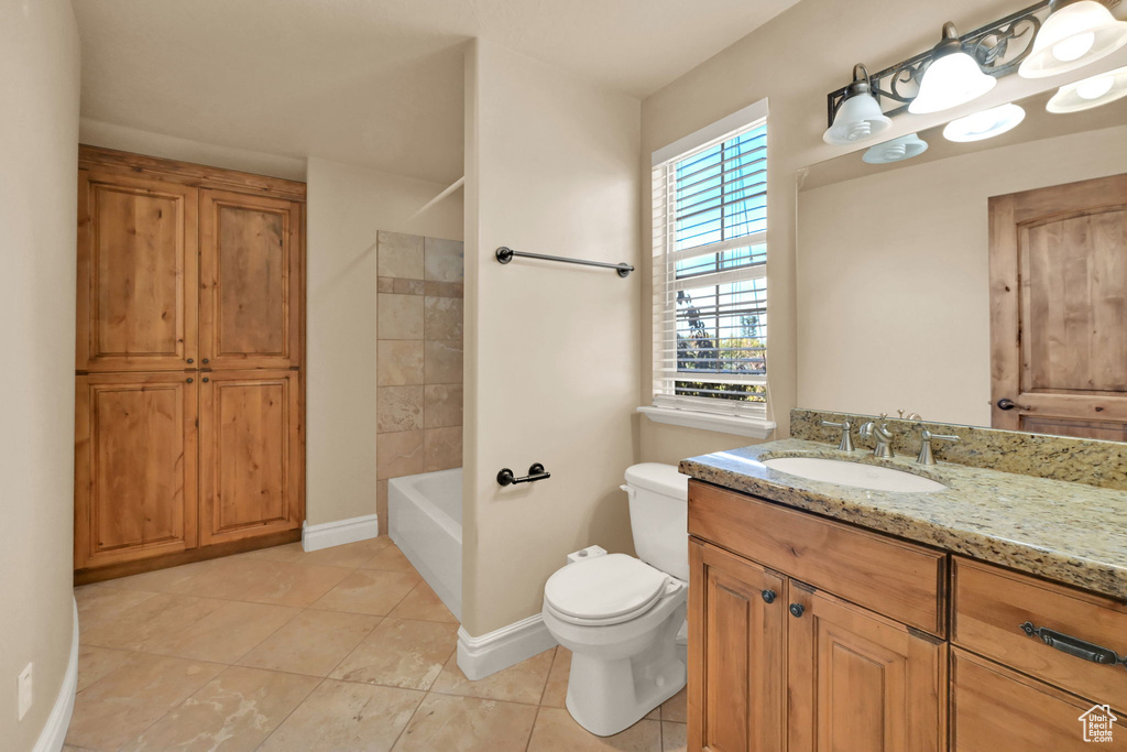 Full bathroom featuring vanity, shower / tub combination, toilet, and tile patterned floors