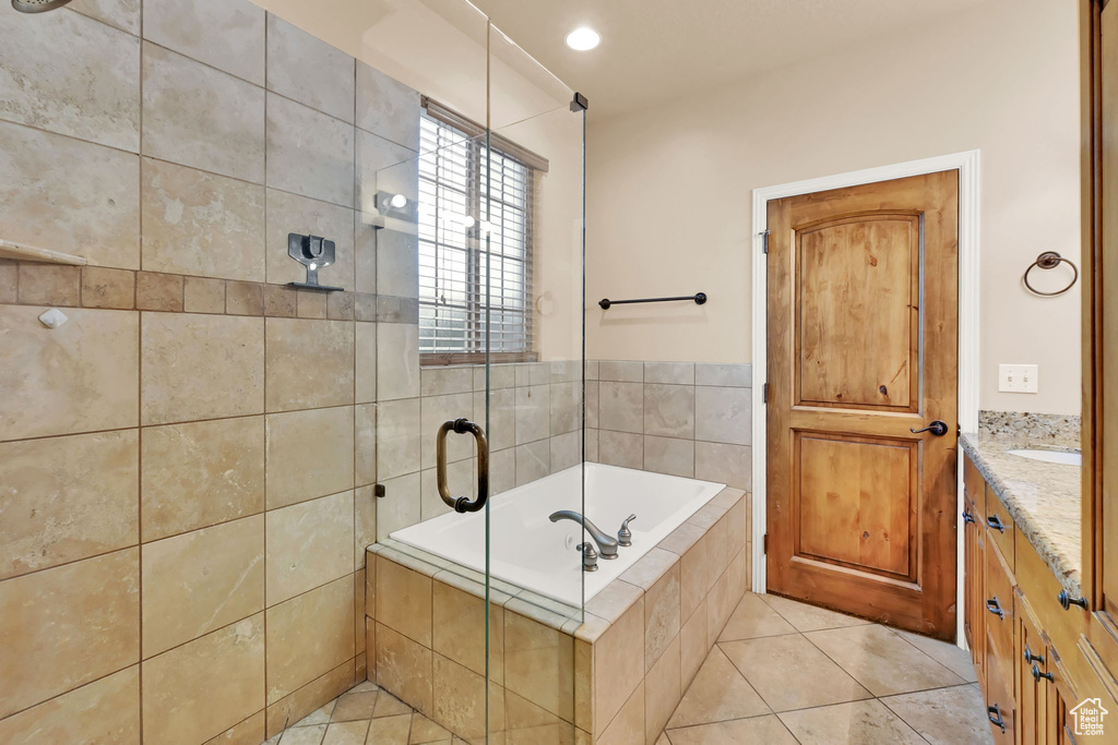 Bathroom featuring vanity, separate shower and tub, and tile patterned flooring