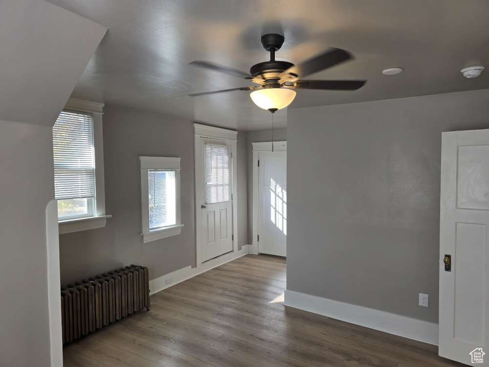 Entryway featuring ceiling fan, hardwood / wood-style flooring, and radiator