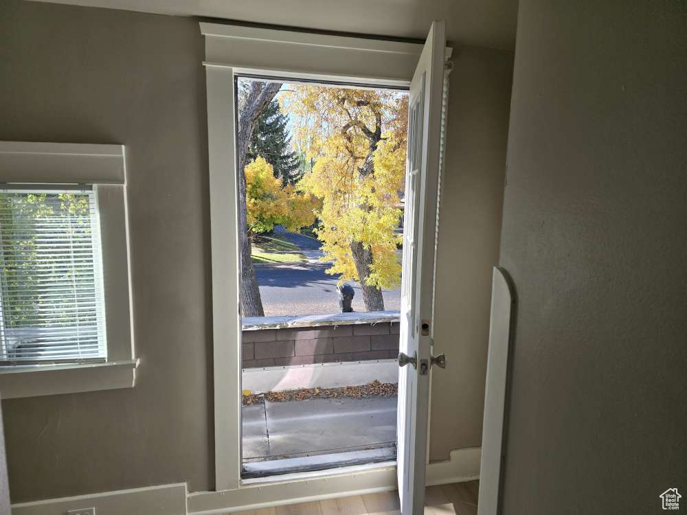 Doorway with light hardwood / wood-style flooring