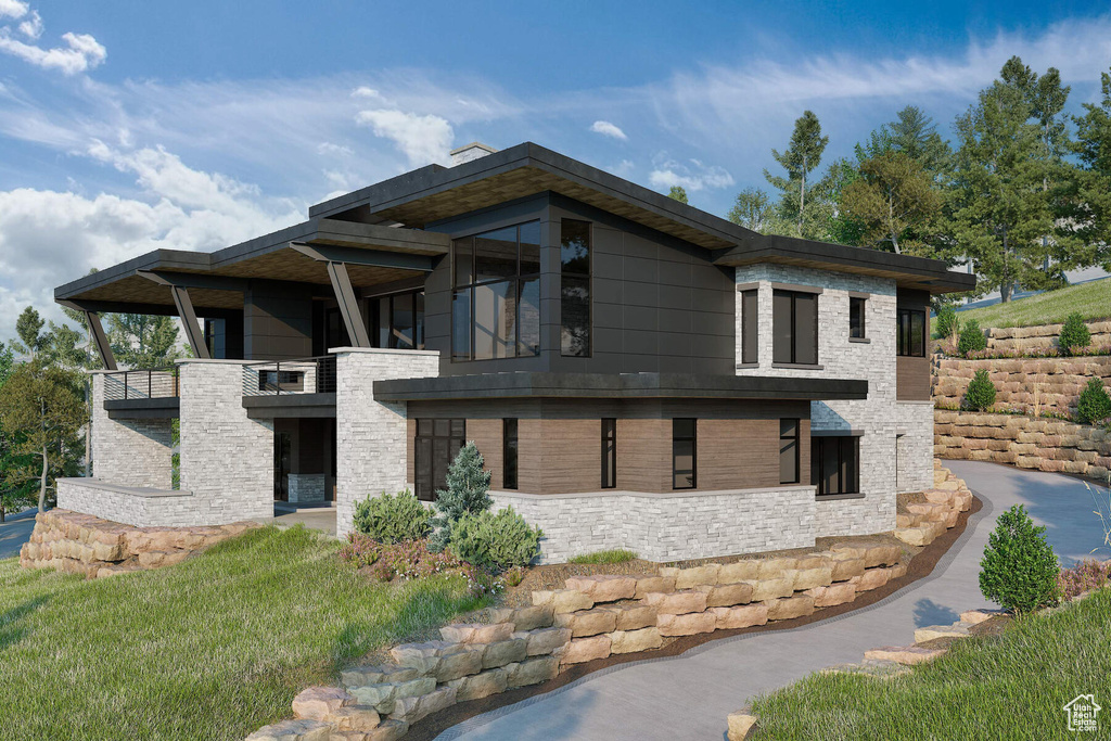 View of side of home featuring a lawn and a balcony