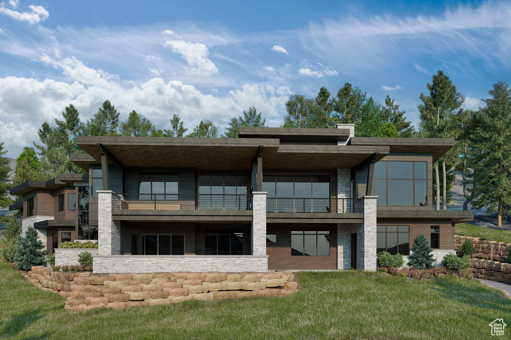 Rear view of house featuring a lawn