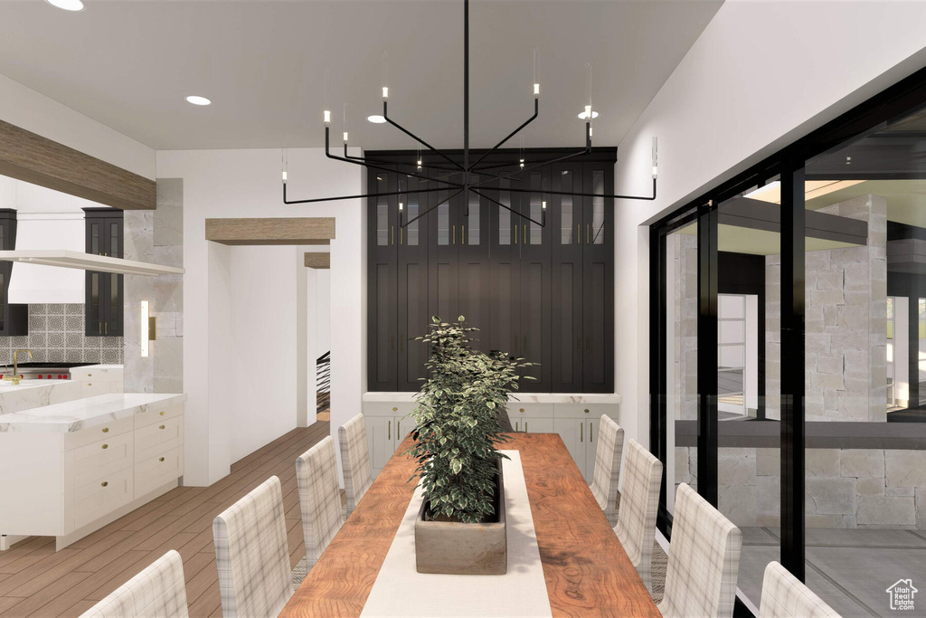 Dining room with a notable chandelier and light wood-type flooring