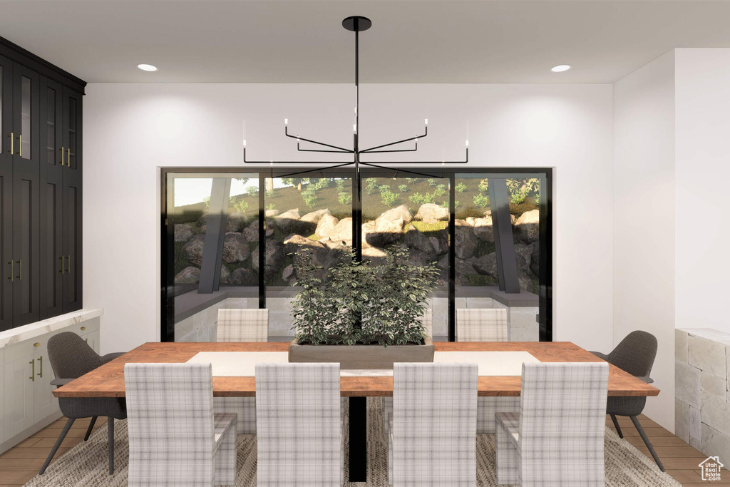 Dining space featuring hardwood / wood-style flooring and an inviting chandelier