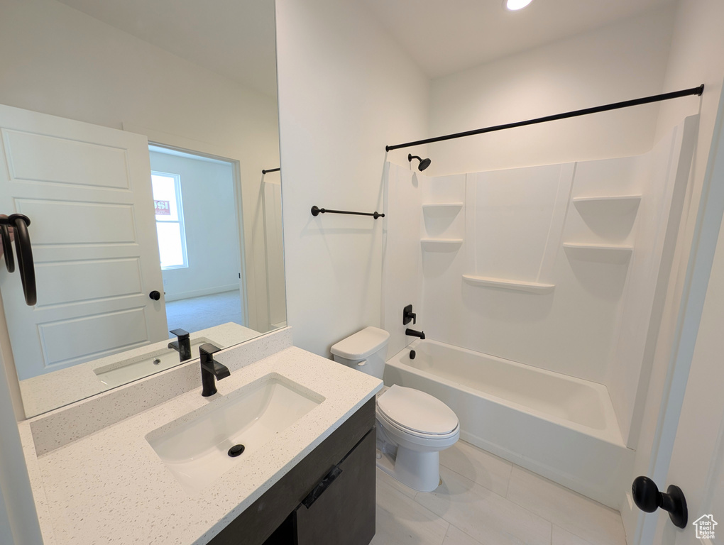 Full bath with vanity, toilet, tile patterned floors, recessed lighting, and  shower combination