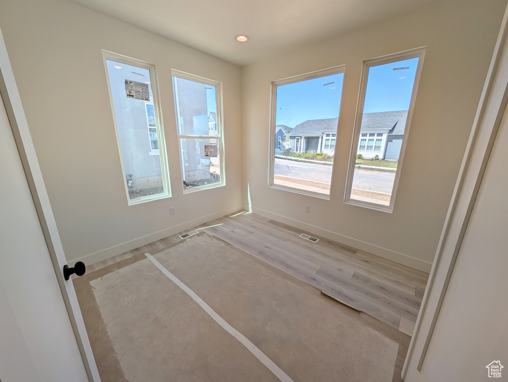 Unfurnished room featuring visible vents, recessed lighting, baseboards, and light wood-type flooring