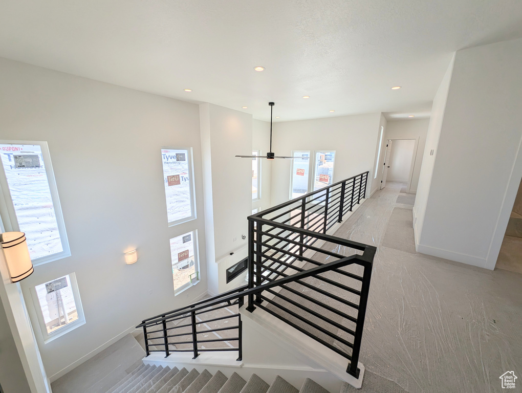 Stairs with recessed lighting and baseboards