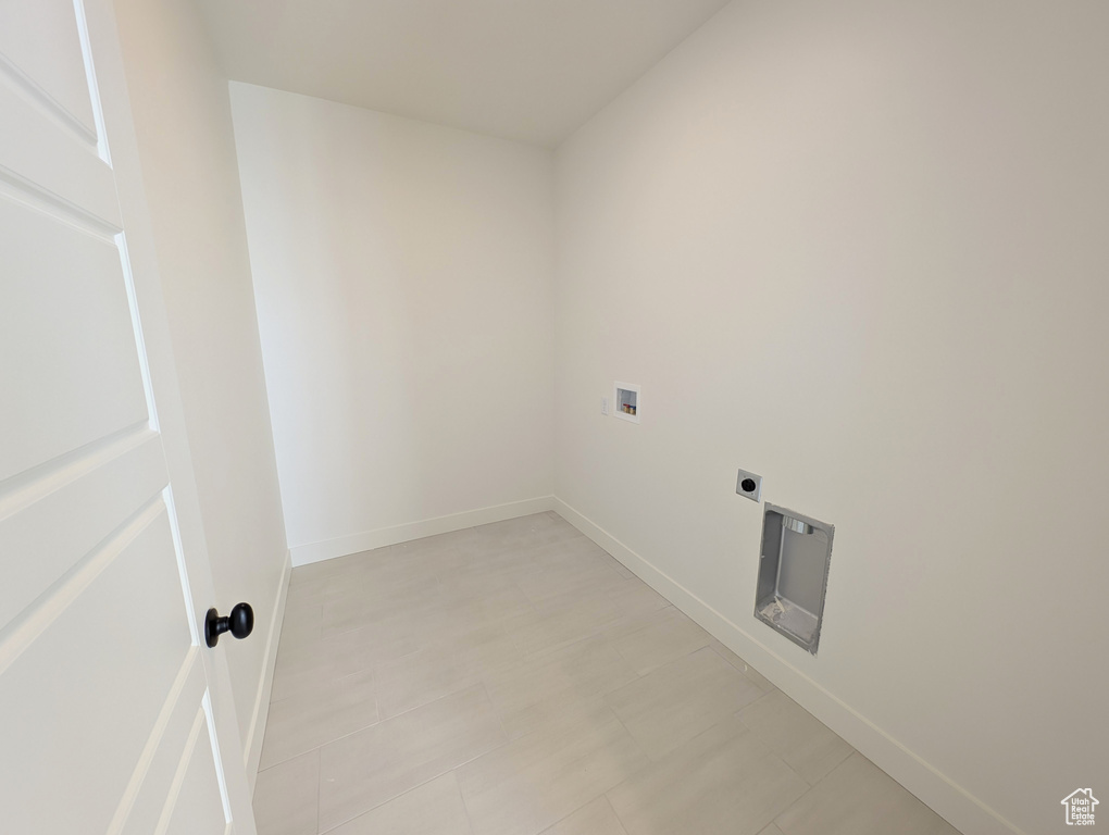 Laundry area featuring baseboards, laundry area, electric dryer hookup, and hookup for a washing machine