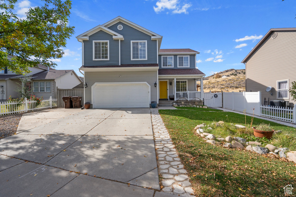 Front facade with a front yard and a garage